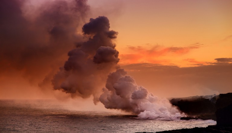 Lava pouring into the ocean creating a huge poisonous plume of smoke at Hawaii's Kilauea Volcano, Volcanoes National Park, Big Island of Hawaii